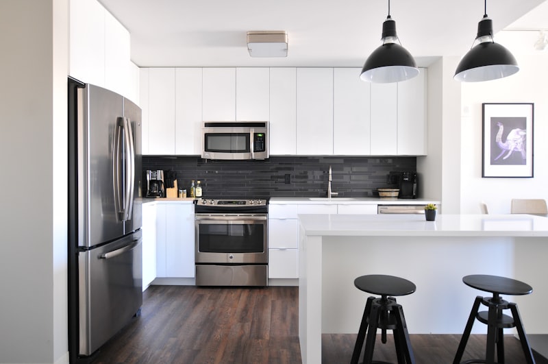 Modern white kitchen remodel with stainless steel appliances